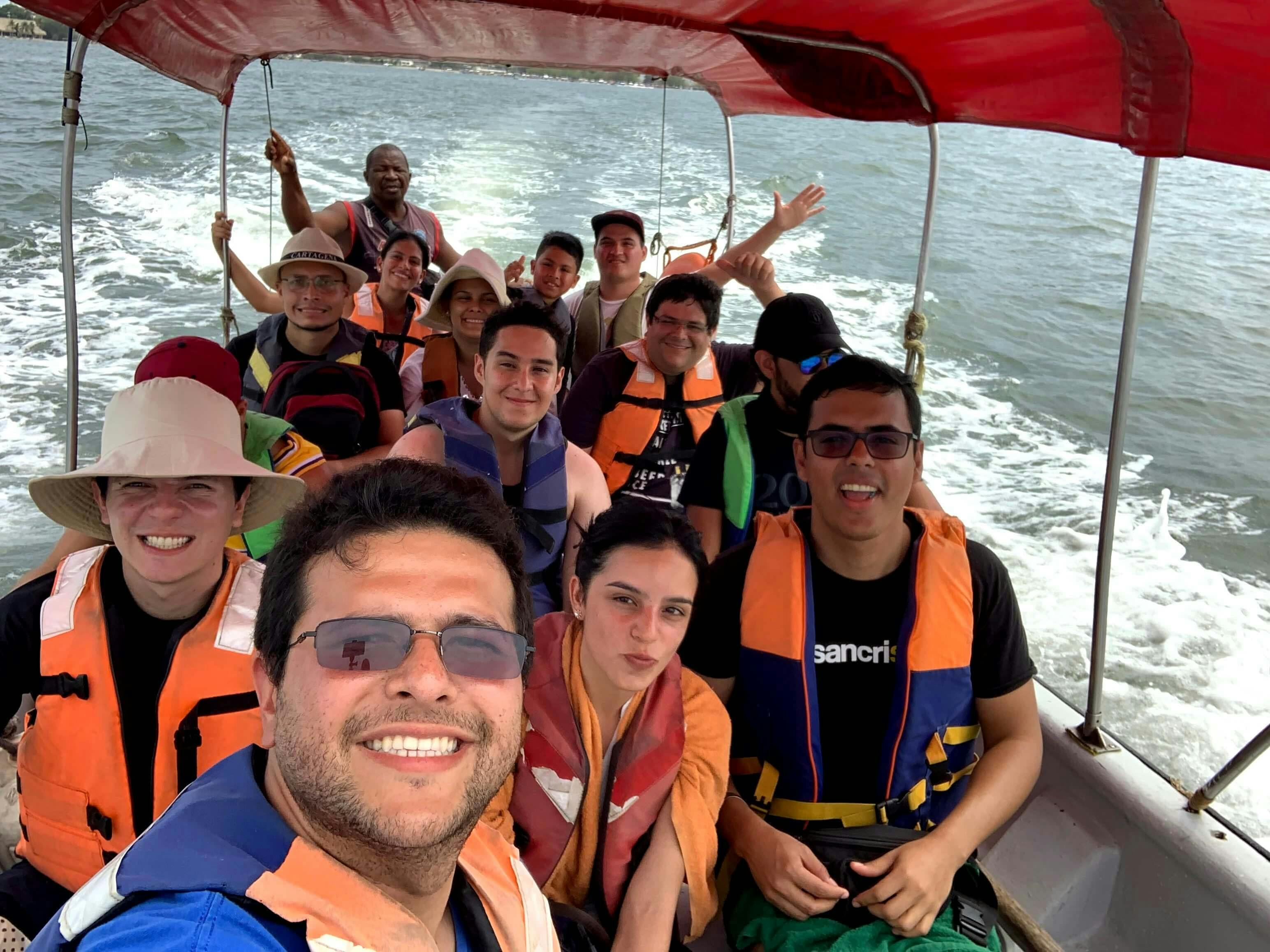 The team in a boat on the sea going to a Playa Blanca.
